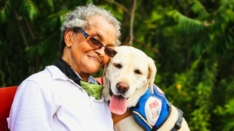 Elderly Woman Sitting Beside a Dog
