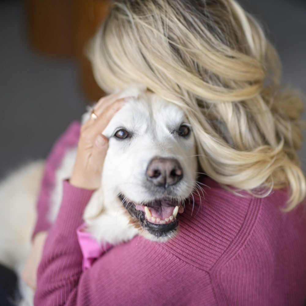 A Teen Girl with her golden retreiver dog at home
